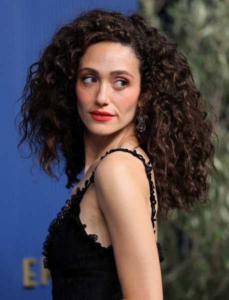 Emmy Rossum posing in a black dress